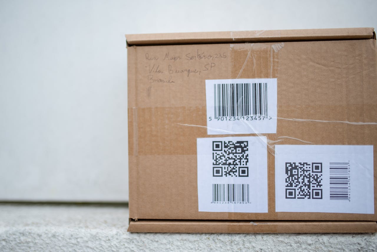 services-04 Close-up of a cardboard package with QR codes and a barcode, ideal for delivery and shipping concepts.